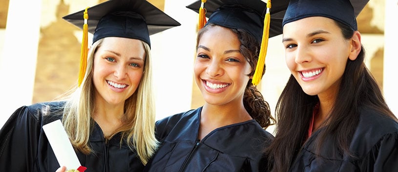Three women in graduation caps and gowns