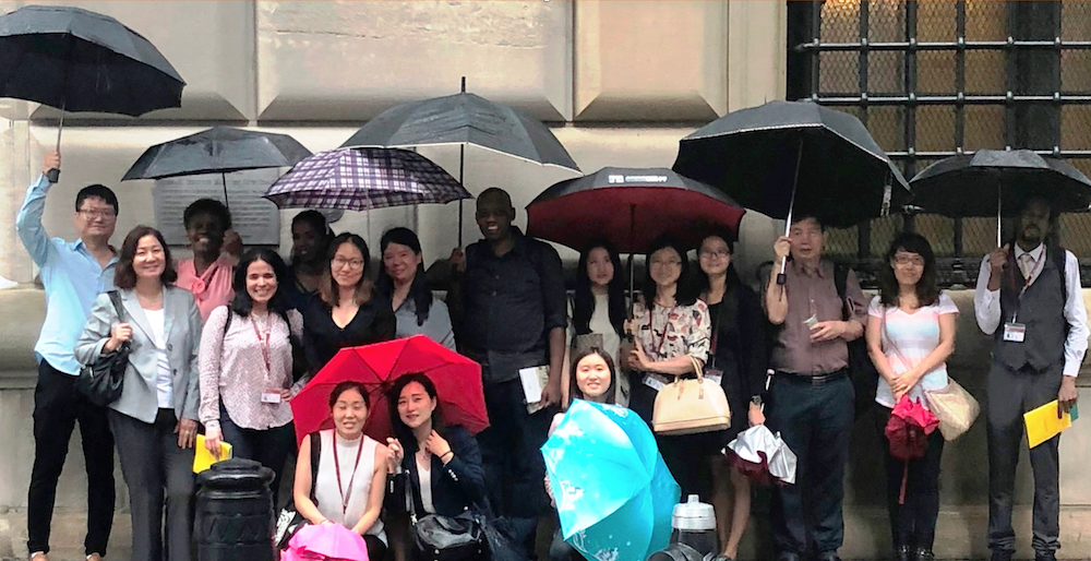 A group of students with umbrellas